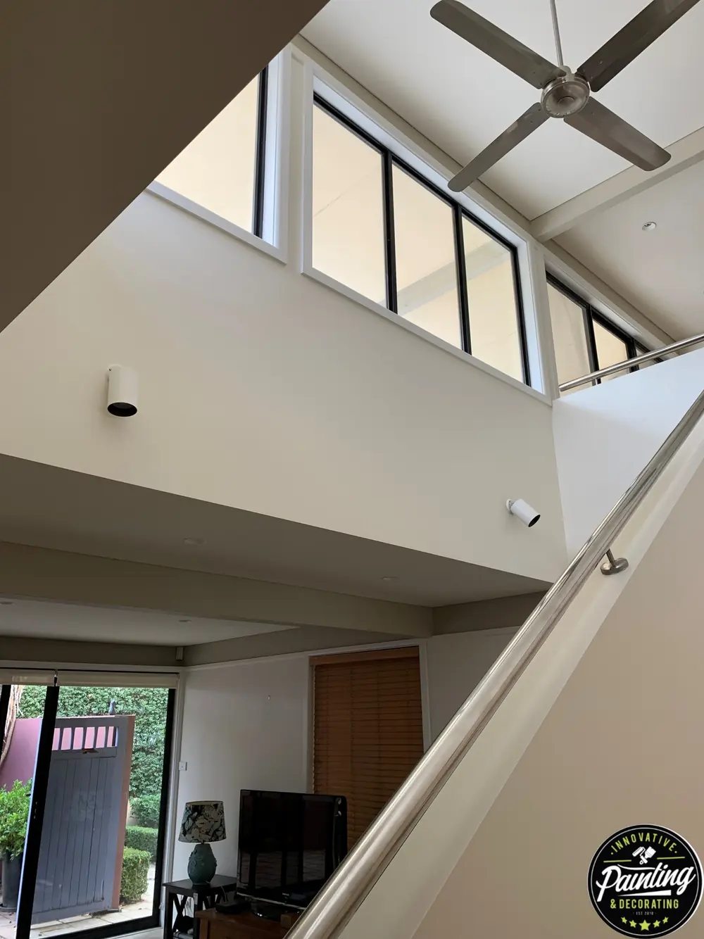 Freshly painted stairwell with clean white walls and ceiling