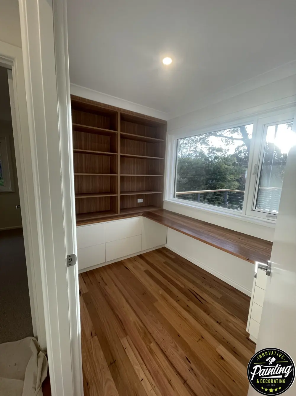 Finished interior room with freshly painted walls, ceiling and built-in shelving