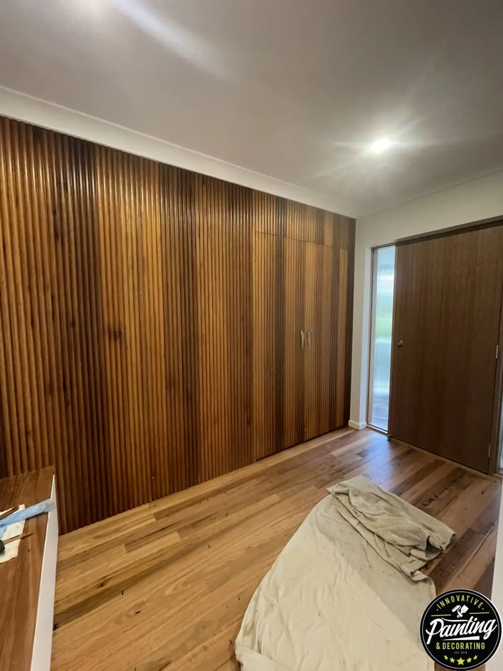 Interior room with a freshly finished ceiling and timber feature wall