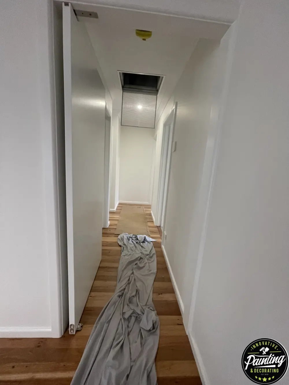 Narrow hallway with freshly painted white walls and trim