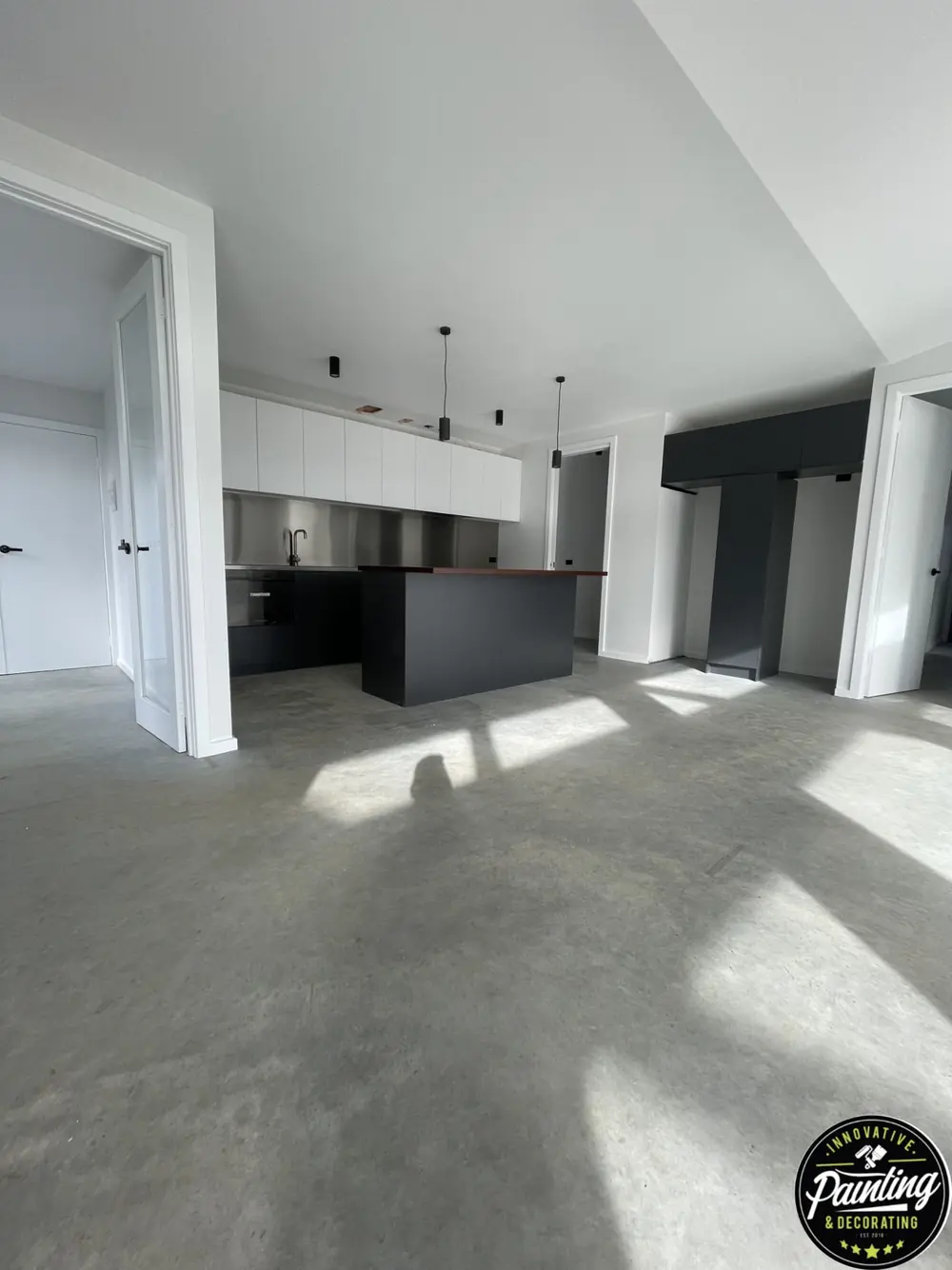 Open-plan interior with freshly painted light walls and ceiling