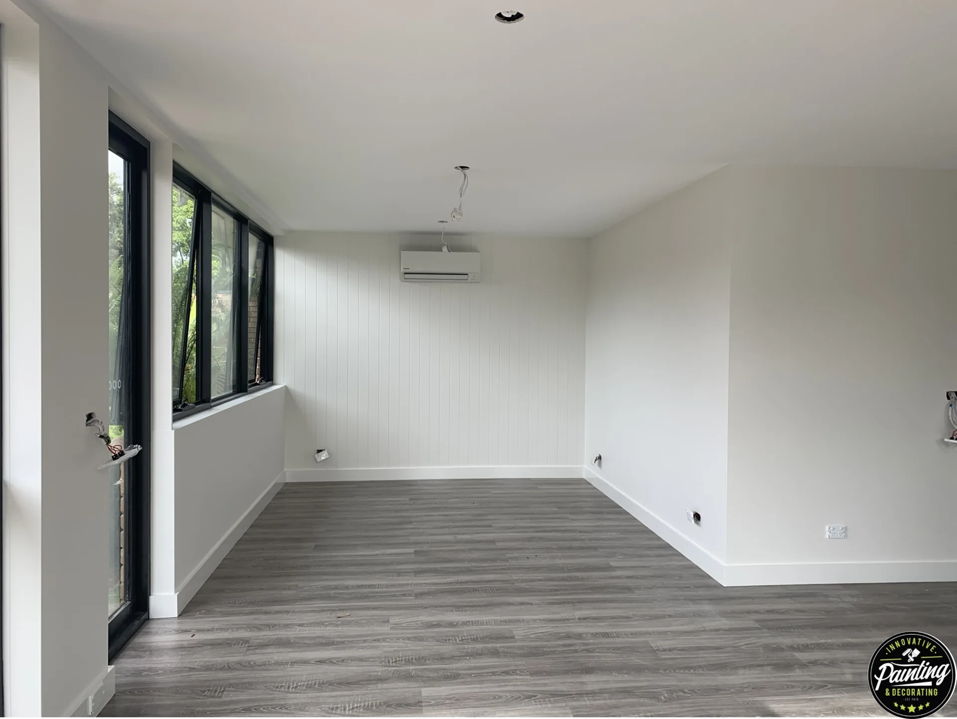 Bright interior room with freshly painted white walls and ceiling