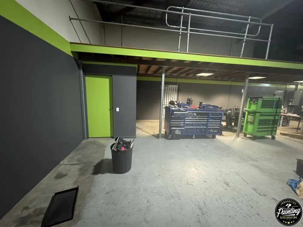 Finished commercial workshop interior with dark walls and lime green accents