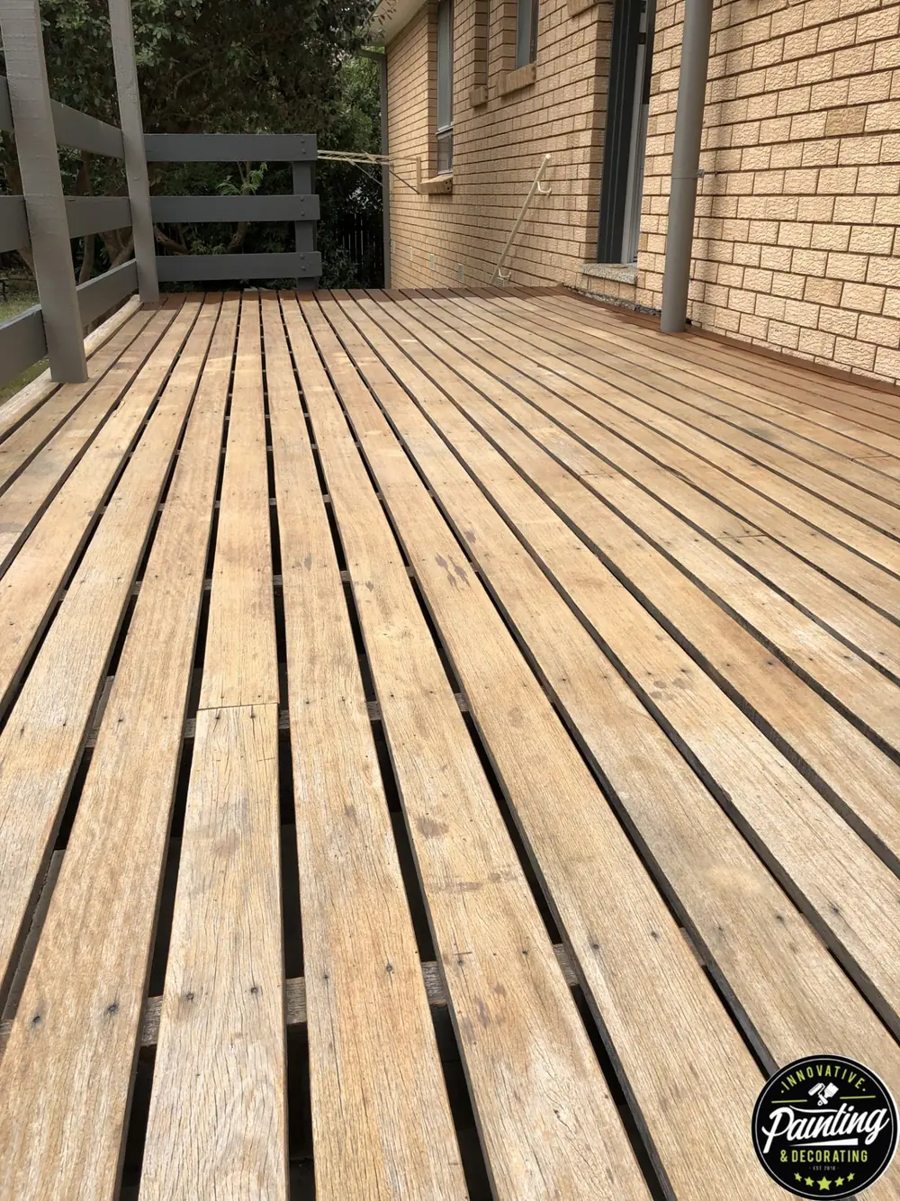Weathered timber deck stripped back during restoration preparation