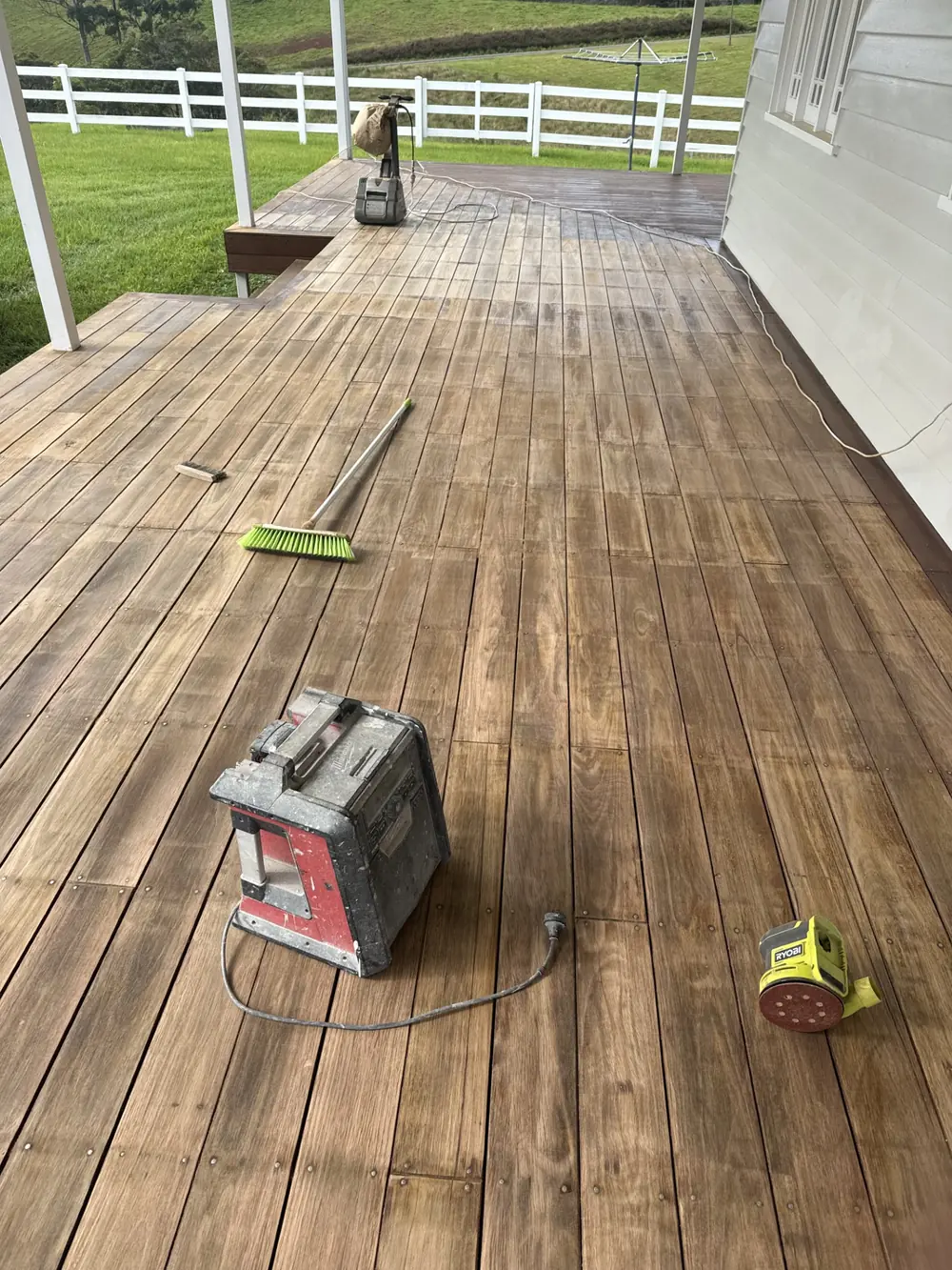 Timber deck being prepared with sanding and restoration equipment
