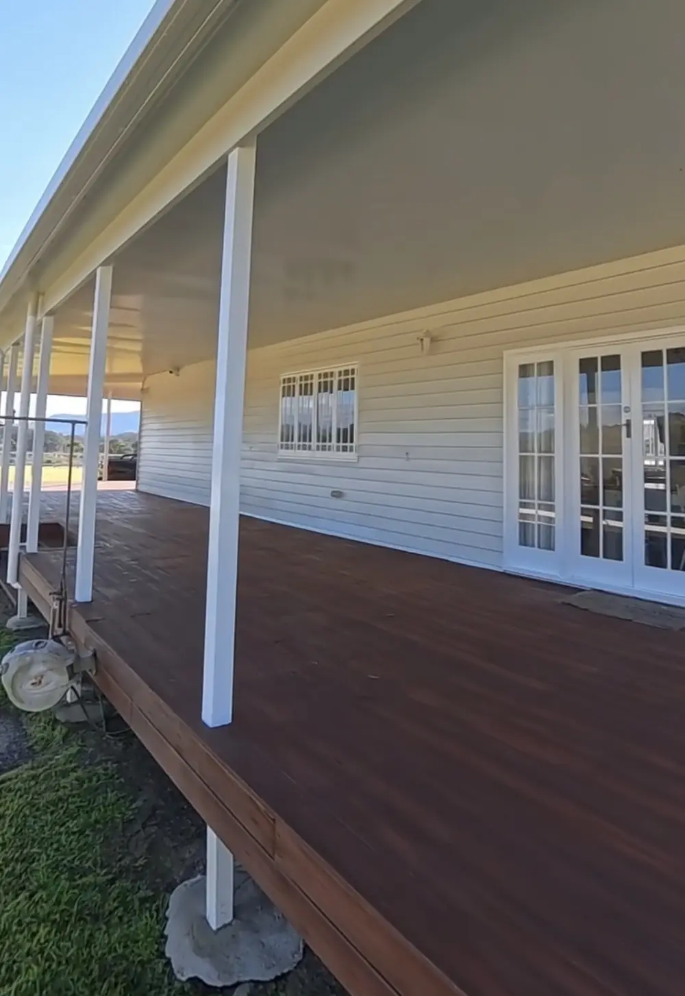 Finished timber deck running along the side of a freshly painted home