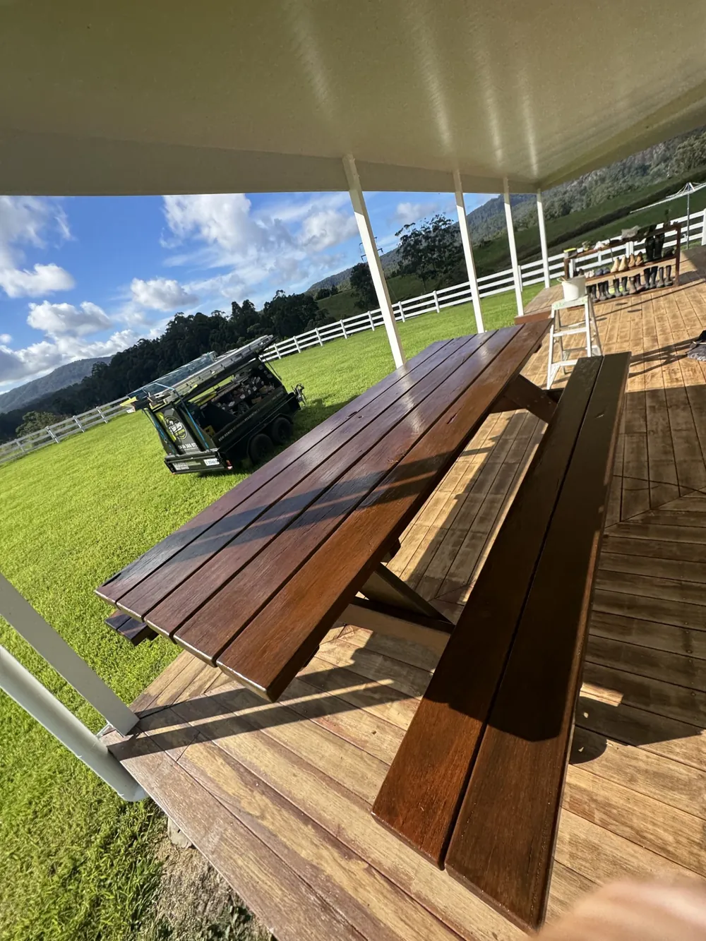 Freshly restored timber outdoor table and deck under a covered patio