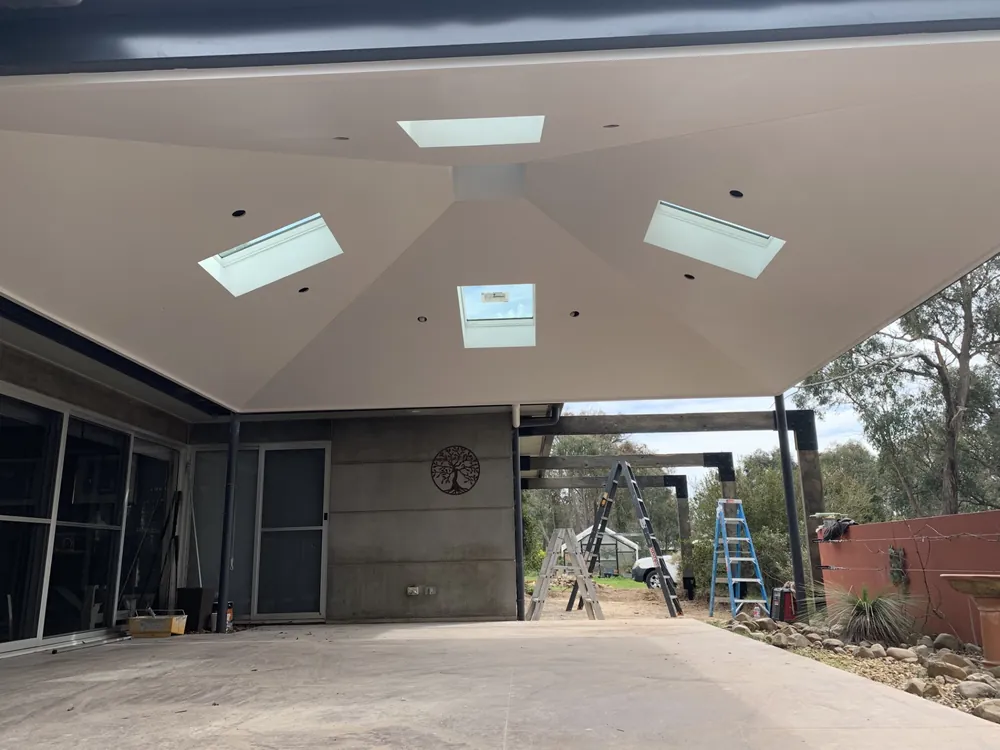 Freshly painted covered outdoor area with skylights and a light ceiling