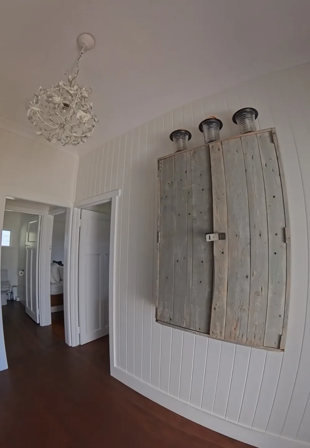 Freshly painted interior with white panelled walls and timber flooring