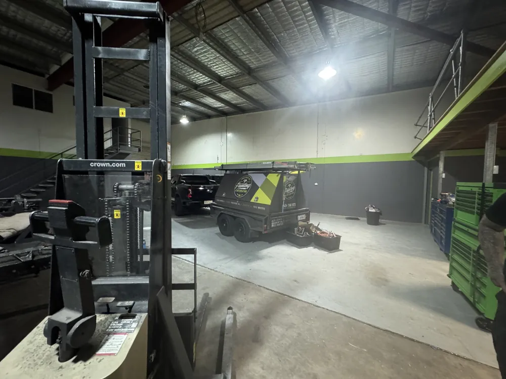 Finished commercial workshop interior with grey walls and green accents
