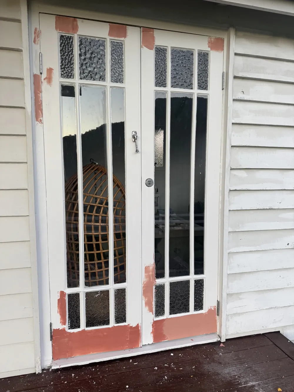 Exterior French doors being prepared and primed before painting