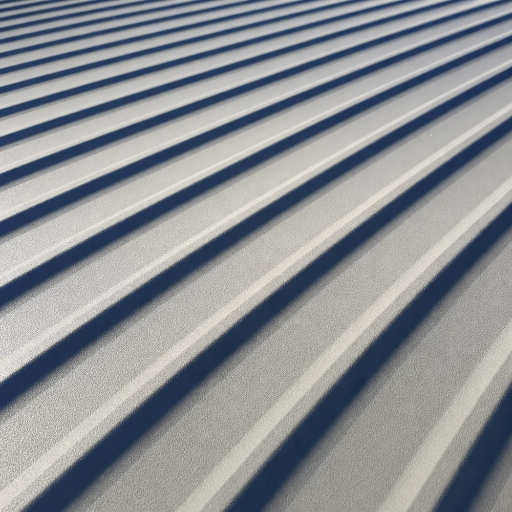 Close-up of grey Colorbond roof sheets with strong diagonal shadows