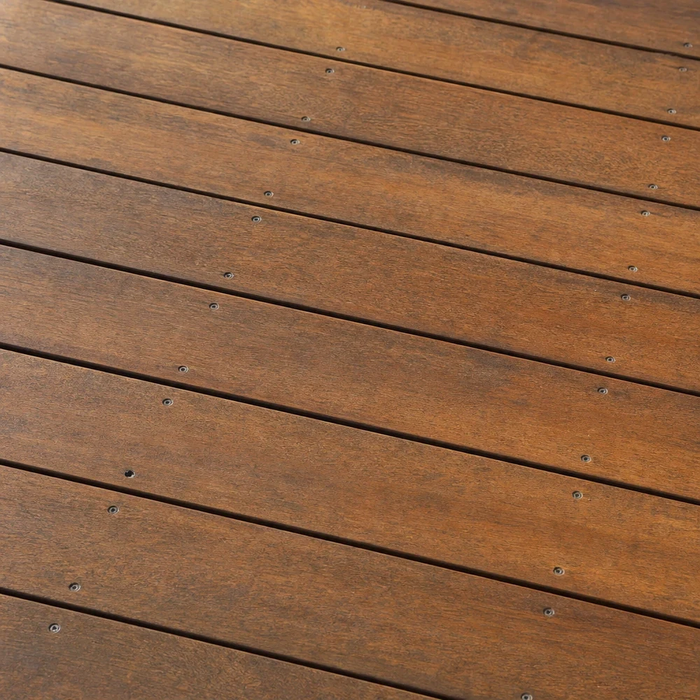 Close-up of restored timber deck boards with warm grain and visible fixings