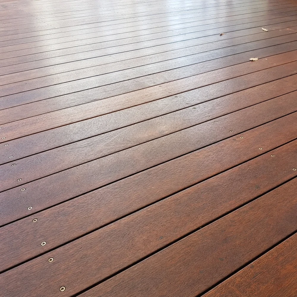 Close-up of restored timber decking with long boards receding across the frame