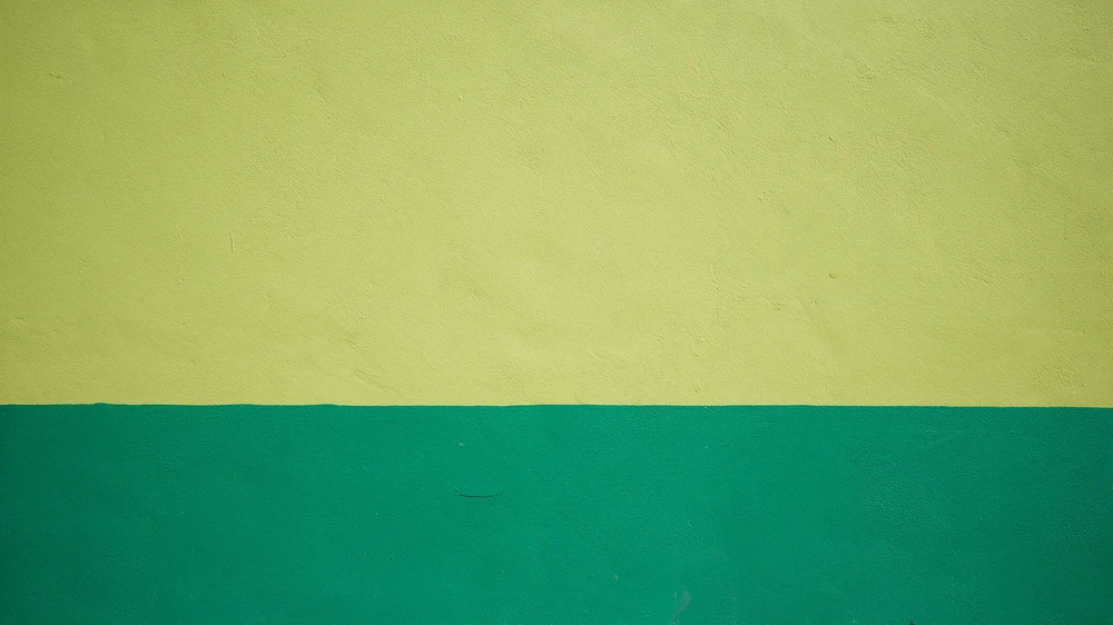 Close-up of a two-tone painted wall in pale lime and teal