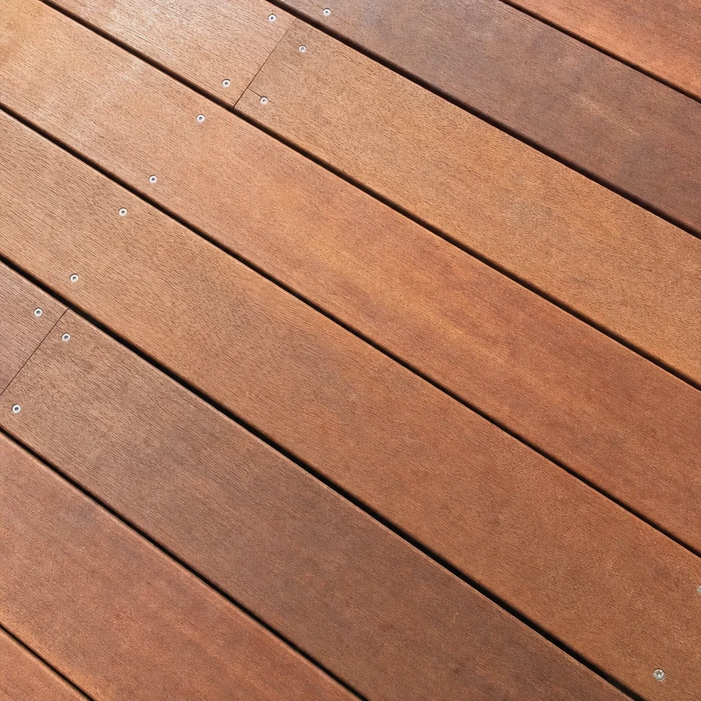 Close-up of restored light-brown timber deck boards laid on a diagonal