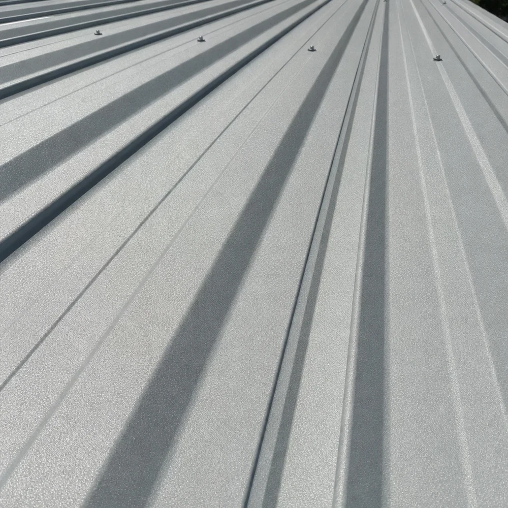 Close-up of silver-grey Colorbond roofing with long narrow shadow lines