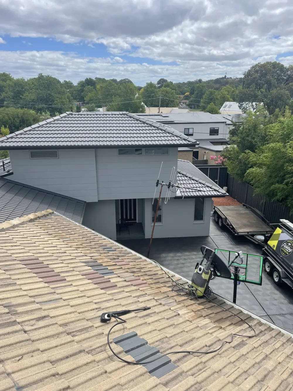 Weathered tiled roof viewed from above during restoration preparation