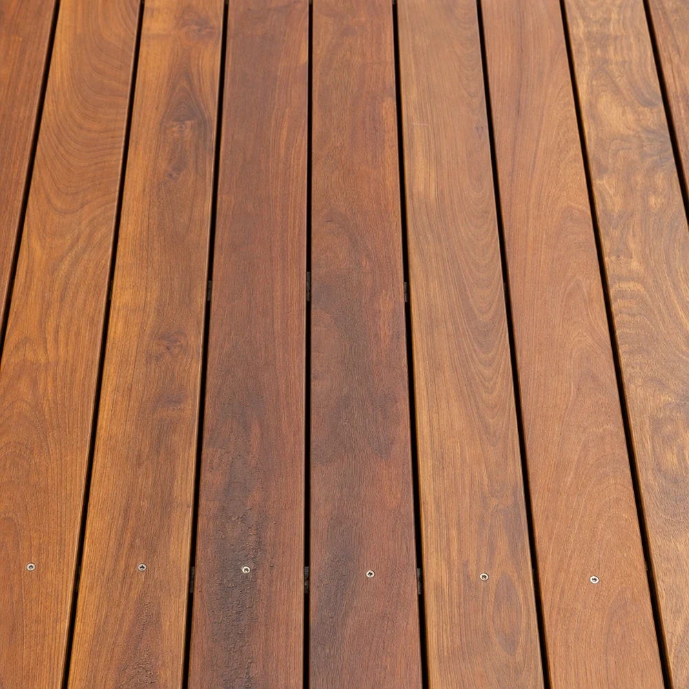 Close-up of restored timber deck boards with a rich warm-brown finish