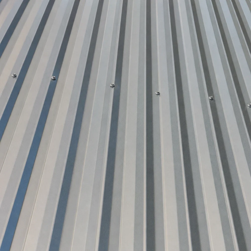 Close-up of clean silver-grey Colorbond roofing with parallel ribs